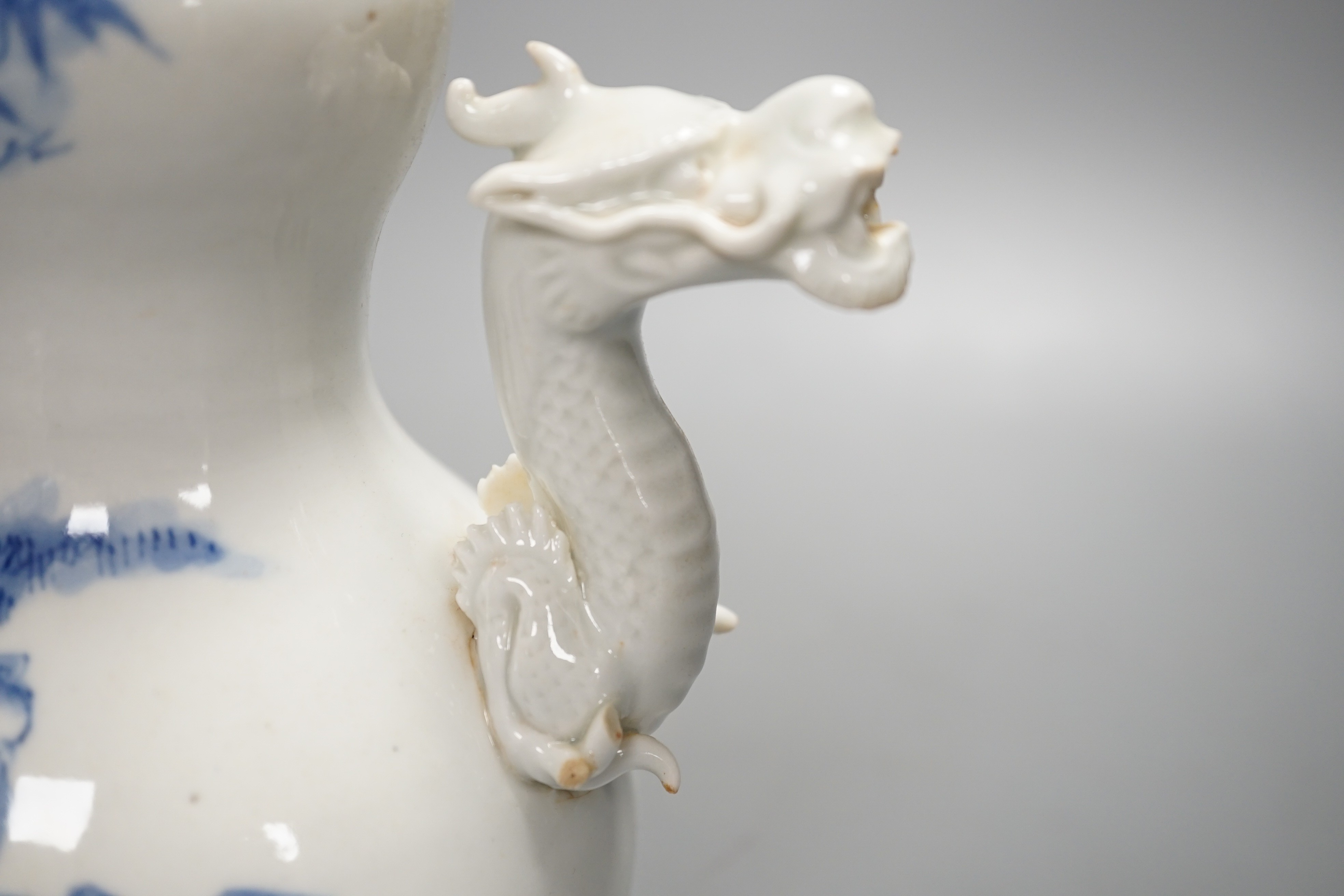 A Japanese Hirado blue and white 'dragon' wine pot, late 19th century, of double gourd shape, (losses) 19.5cm